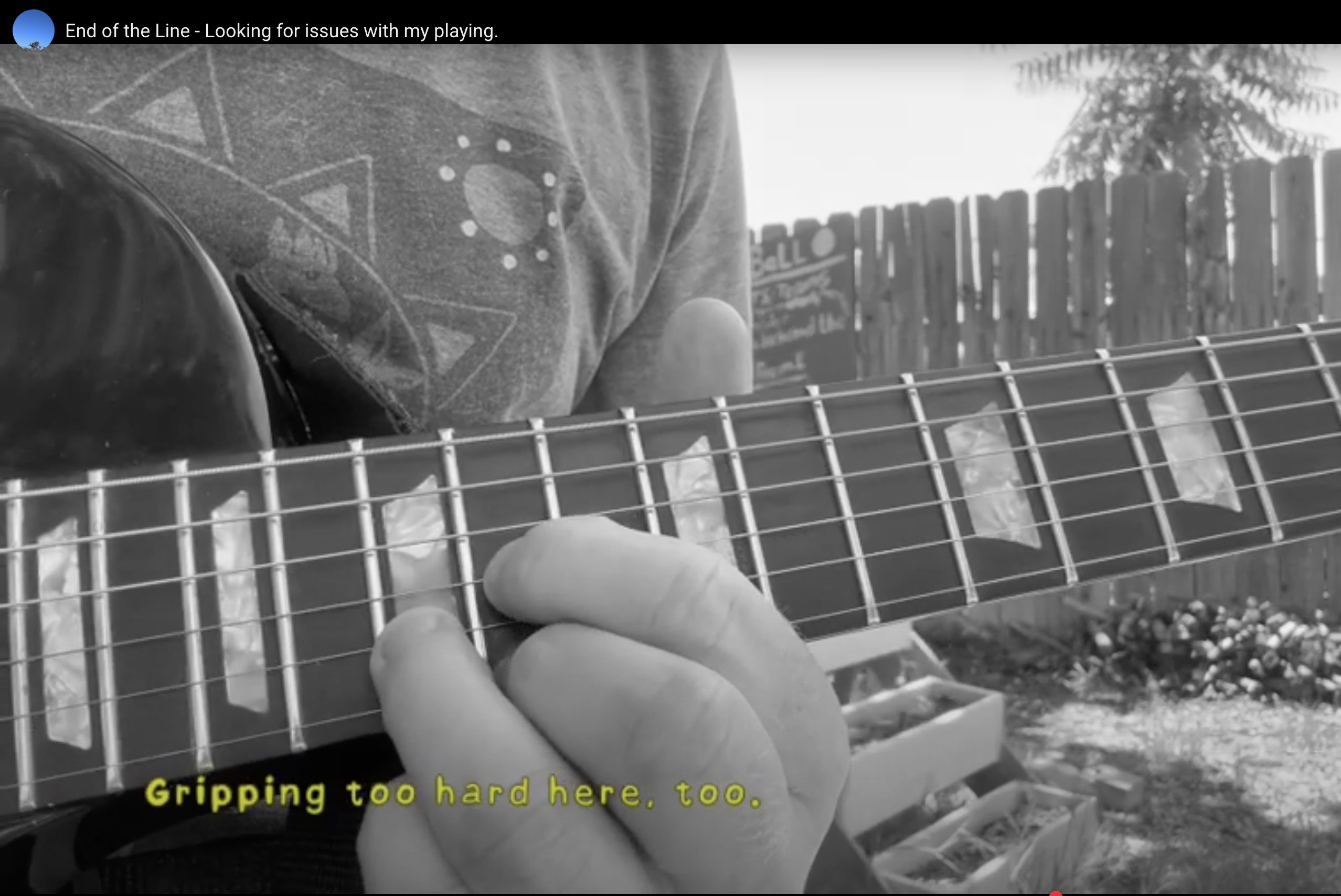 close up of a hand on a guitar neck
